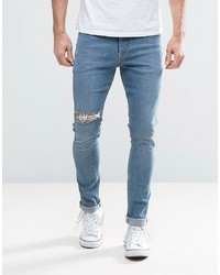 blaue enge Jeans mit Destroyed-Effekten von ASOS DESIGN