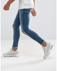 blaue enge Jeans mit Destroyed-Effekten von ASOS DESIGN