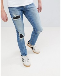 blaue enge Jeans mit Destroyed-Effekten von ASOS DESIGN