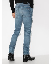 blaue enge Jeans mit Destroyed-Effekten von Amiri