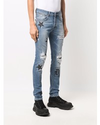 blaue enge Jeans mit Destroyed-Effekten von John Richmond