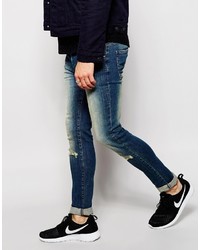 blaue enge Jeans mit Destroyed-Effekten von Asos