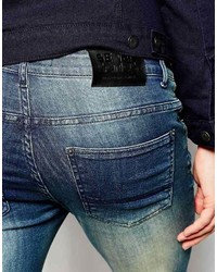 blaue enge Jeans mit Destroyed-Effekten von Asos