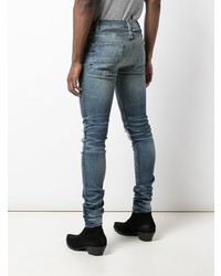 blaue enge Jeans mit Destroyed-Effekten von Amiri