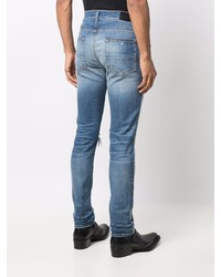 blaue enge Jeans mit Destroyed-Effekten von Amiri
