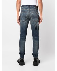 dunkelblaue enge Jeans mit Destroyed-Effekten von Amiri