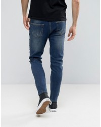 dunkelblaue enge Jeans mit Destroyed-Effekten