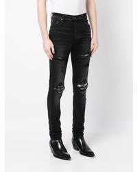 dunkelblaue enge Jeans mit Destroyed-Effekten von Amiri