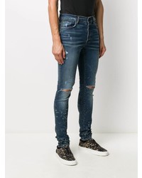 dunkelblaue enge Jeans mit Destroyed-Effekten von Amiri