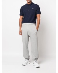 dunkelblaues horizontal gestreiftes Polohemd von Lacoste