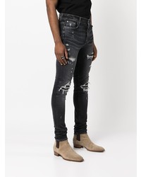 dunkelgraue enge Jeans mit Destroyed-Effekten von Amiri