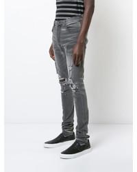 graue enge Jeans mit Destroyed-Effekten von Amiri