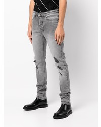 graue enge Jeans mit Destroyed-Effekten von Ksubi