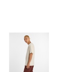 hellbeige T-Shirt mit einem Rundhalsausschnitt von New Balance