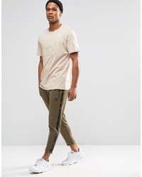 hellbeige T-Shirt mit einem Rundhalsausschnitt von Puma