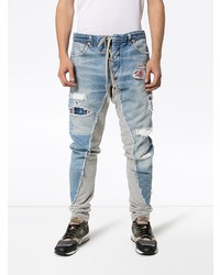 hellblaue enge Jeans mit Destroyed-Effekten von Greg Lauren