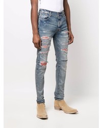 hellblaue enge Jeans mit Destroyed-Effekten von Amiri