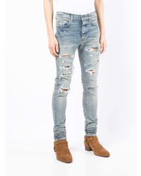 hellblaue enge Jeans mit Destroyed-Effekten von Amiri