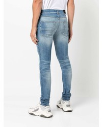 hellblaue enge Jeans mit Destroyed-Effekten von Amiri