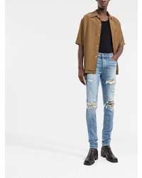 hellblaue enge Jeans mit Destroyed-Effekten von Amiri