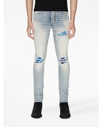 hellblaue enge Jeans mit Destroyed-Effekten von Amiri