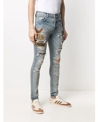 hellblaue enge Jeans mit Destroyed-Effekten von Amiri