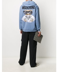 hellblauer bestickter Pullover mit einem Kapuze von Moschino