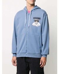 hellblauer bestickter Pullover mit einem Kapuze von Moschino