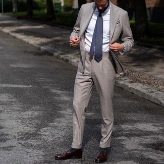 30 Jährige: Mehrfarbiges Einstecktuch kombinieren – 329 Herren Outfits: Die Paarung aus einem grauen Anzug und einem mehrfarbigen Einstecktuch ist eine komfortable Wahl, um Besorgungen in der Stadt zu erledigen. Fühlen Sie sich mutig? Komplettieren Sie Ihr Outfit mit dunkelbraunen Leder Slippern.