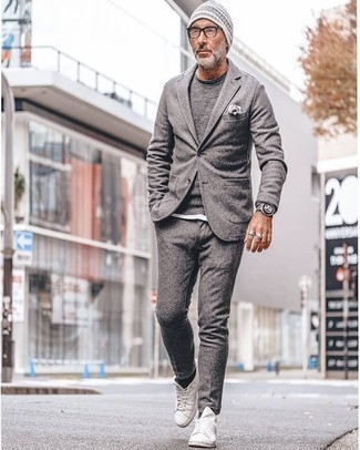 Grauen Wollanzug kombinieren – 411 Herren Outfits: Erwägen Sie das Tragen von einem grauen Wollanzug und einem grauen Pullover mit einem Rundhalsausschnitt für einen stilvollen, eleganten Look. Fühlen Sie sich mutig? Entscheiden Sie sich für weißen Segeltuch niedrige Sneakers.