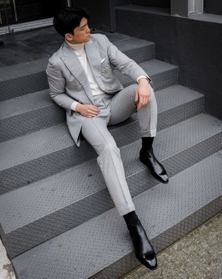 Grauen Anzug kombinieren – 1200+ Herren Outfits warm Wetter: Kombinieren Sie einen grauen Anzug mit einem weißen Rollkragenpullover für eine klassischen und verfeinerte Silhouette. Ergänzen Sie Ihr Look mit schwarzen Chelsea Boots aus Leder.