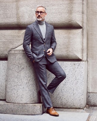 Braune Leder Oxford Schuhe kombinieren – 1200+ Herren Outfits: Die Kombination aus einem dunkelgrauen Wollanzug mit Schottenmuster und einem grauen Rollkragenpullover eignet sich hervorragend zum Ausgehen oder für modisch-lässige Anlässe. Heben Sie dieses Ensemble mit braunen Leder Oxford Schuhen hervor.