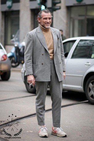 50 Jährige: Grauen Wollanzug kombinieren – 7 Smart-Casual Herren Outfits: Kombinieren Sie einen grauen Wollanzug mit einem beige Wollrollkragenpullover für eine klassischen und verfeinerte Silhouette. Fühlen Sie sich ideenreich? Komplettieren Sie Ihr Outfit mit hellbeige Sportschuhen.