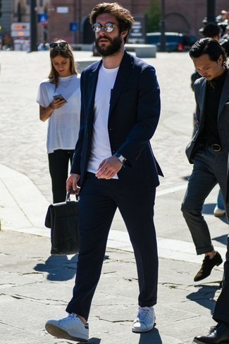 dunkelblauer Anzug, weißes T-Shirt mit einem Rundhalsausschnitt, weiße Leder niedrige Sneakers, schwarze Leder Aktentasche für Herren