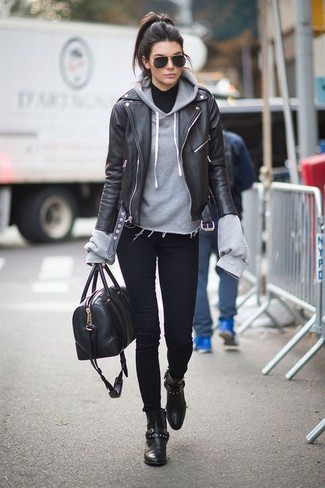 schwarze Leder Bikerjacke, grauer Pullover mit einer Kapuze, schwarzer Rollkragenpullover, schwarze enge Jeans für Damen