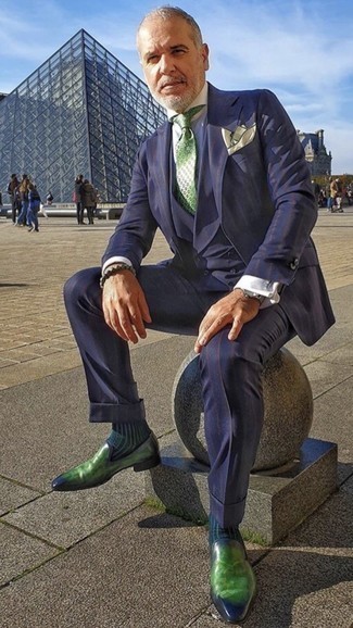 Grüne bedruckte Krawatte kombinieren – 27 Herren Outfits: Vereinigen Sie einen dunkelblauen vertikal gestreiften Dreiteiler mit einer grünen bedruckten Krawatte für einen stilvollen, eleganten Look. Grüne Leder Slipper liefern einen wunderschönen Kontrast zu dem Rest des Looks.