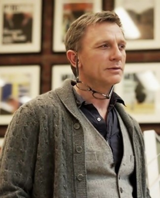 Daniel Craig trägt graue Strickjacke mit einem Schalkragen, graue Wollweste, schwarzes Langarmhemd