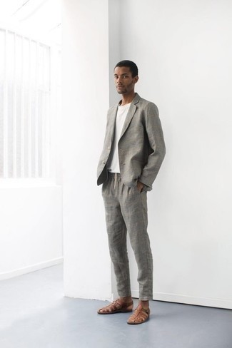 Braune Ledersandalen kombinieren – 43 Casual Herren Outfits warm Wetter: Erwägen Sie das Tragen von einem grauen Anzug und einem weißen T-Shirt mit einem Rundhalsausschnitt, um einen modischen Freizeitlook zu kreieren. Braune Ledersandalen verleihen einem klassischen Look eine neue Dimension.