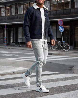 Dunkelgraue Jeans kombinieren – 133 Lässige Frühling Herren Outfits: Entscheiden Sie sich für Komfort in einer dunkelblauen Harrington-Jacke und dunkelgrauen Jeans. Weiße und schwarze Segeltuch niedrige Sneakers fügen sich nahtlos in einer Vielzahl von Outfits ein. So einfach kann ein stylisches Frühlings-Outfit sein.