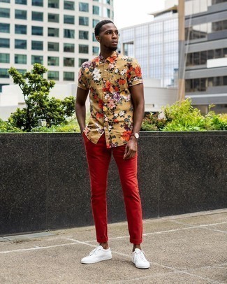 Rote Chinohose kombinieren – 365 Herren Outfits: Kombinieren Sie ein beige Kurzarmhemd mit Blumenmuster mit einer roten Chinohose für ein bequemes Outfit, das außerdem gut zusammen passt. Weiße Segeltuch niedrige Sneakers sind eine gute Wahl, um dieses Outfit zu vervollständigen.