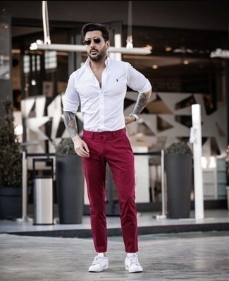 Rote Chinohose kombinieren – 365 Herren Outfits: Vereinigen Sie ein weißes Langarmhemd mit einer roten Chinohose, um mühelos alles zu meistern, was auch immer der Tag bringen mag. Fühlen Sie sich mutig? Ergänzen Sie Ihr Outfit mit weißen Segeltuch niedrigen Sneakers.