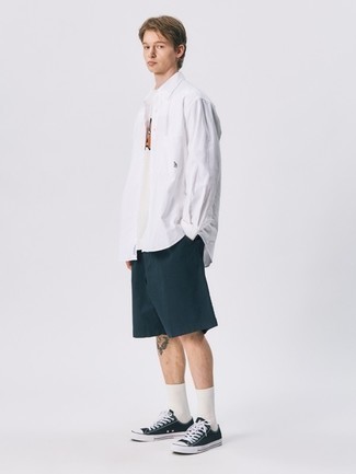 Dunkelblaue Shorts kombinieren – 500+ Herren Outfits: Kombinieren Sie ein weißes Langarmhemd mit dunkelblauen Shorts, um mühelos alles zu meistern, was auch immer der Tag bringen mag. Ergänzen Sie Ihr Look mit schwarzen und weißen Segeltuch niedrigen Sneakers.