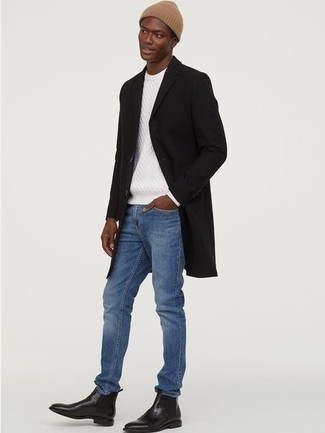 schwarzer Mantel, weißer Strickpullover, blaue Jeans, schwarze Chelsea Boots aus Leder für Herren