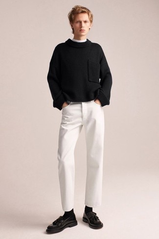 Wie schwarzen Pullover mit einem Rundhalsausschnitt mit weißer Jeans zu kombinieren – 8 Herren Outfits: Kombinieren Sie einen schwarzen Pullover mit einem Rundhalsausschnitt mit weißen Jeans, um einen lockeren, aber dennoch stylischen Look zu erhalten. Schwarze Leder Slipper mit Quasten bringen Eleganz zu einem ansonsten schlichten Look.