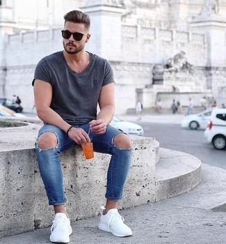 Dunkelblaue enge Jeans kombinieren – 81 Herren Outfits heiß Wetter: Kombinieren Sie ein graues T-Shirt mit einem Rundhalsausschnitt mit dunkelblauen engen Jeans für einen entspannten Wochenend-Look. Weiße Sportschuhe sind eine gute Wahl, um dieses Outfit zu vervollständigen.