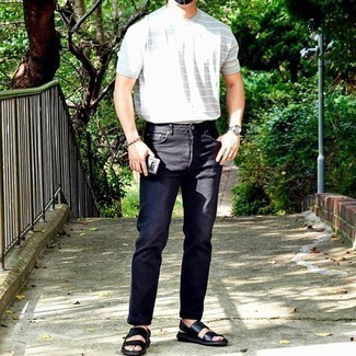 Dunkelblaue Jeans kombinieren – 500+ Lässige Herren Outfits: Vereinigen Sie ein graues horizontal gestreiftes T-Shirt mit einem Rundhalsausschnitt mit dunkelblauen Jeans für einen entspannten Wochenend-Look. Fühlen Sie sich ideenreich? Vervollständigen Sie Ihr Outfit mit schwarzen Ledersandalen.