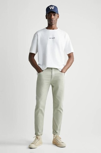 weißes T-Shirt mit einem Rundhalsausschnitt, mintgrüne Jeans, hellbeige hohe Sneakers aus Segeltuch, dunkelblaue und weiße bedruckte Baseballkappe für Herren