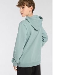 mintgrüner bedruckter Pullover mit einem Kapuze von Puma