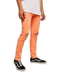 orange enge Jeans mit Destroyed-Effekten