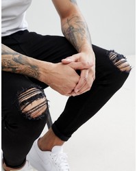 schwarze enge Jeans mit Destroyed-Effekten von Aces Couture